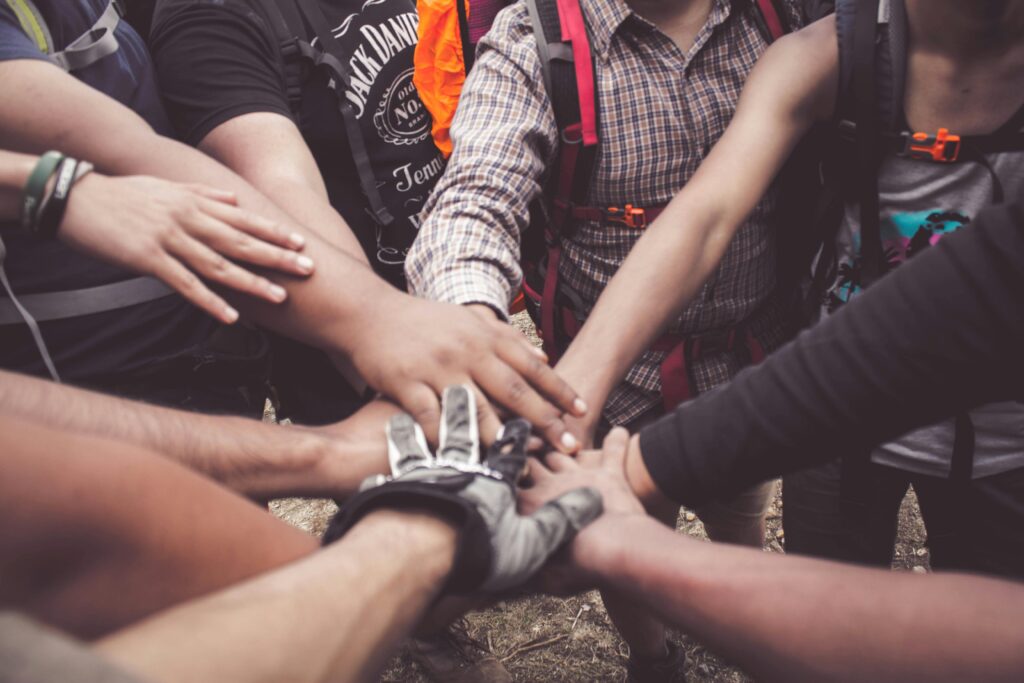 A group of people putting their hands together