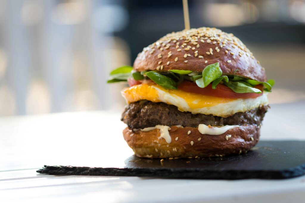 A cheeseburger on a slate plate